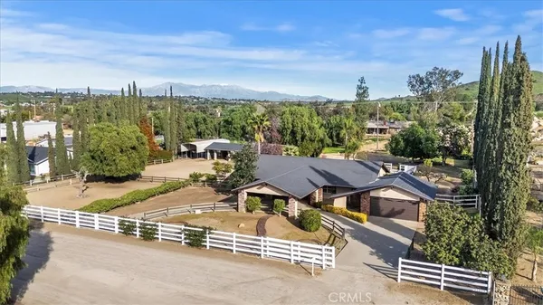 an aerial view of a house with garden space and street view
