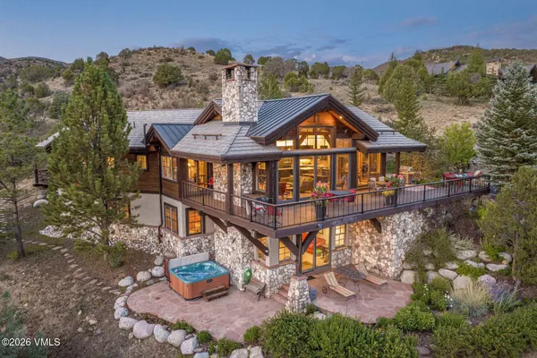 an aerial view of a house with outdoor space and sitting area