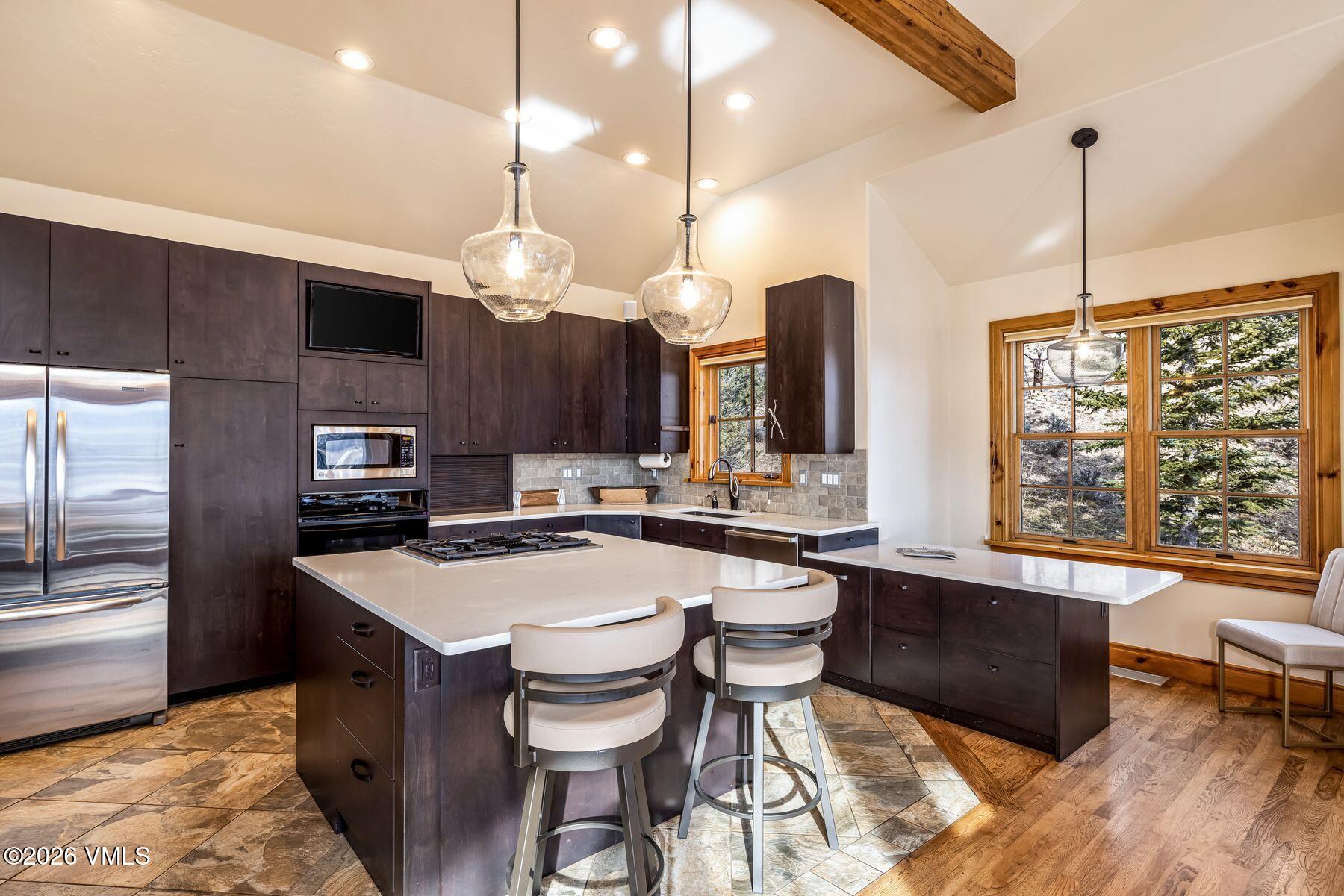 62 Elk Run Edwards, CO 81632 - Photo 20 of 43 a kitchen with a table chairs stove and microwave