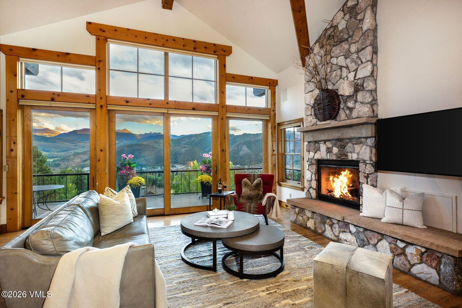 62 Elk Run Edwards, CO 81632 - Photo 2 of 43 a living room with furniture a fireplace and a flat screen tv