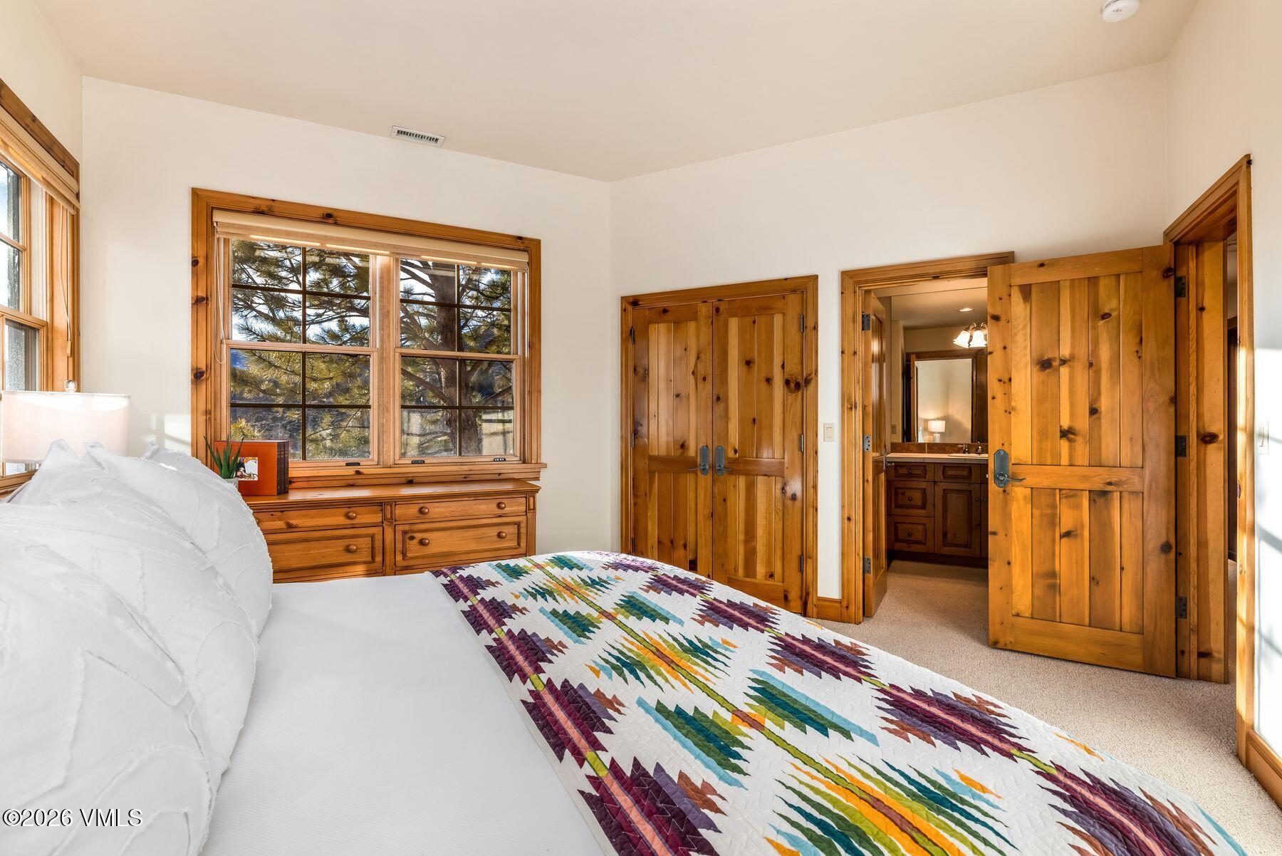 62 Elk Run Edwards, CO 81632 - Photo 28 of 43 a bedroom with a bed and a dresser next to a window