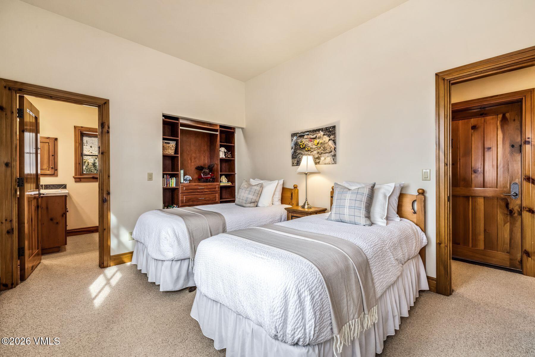 62 Elk Run Edwards, CO 81632 - Photo 34 of 43 a bedroom with bed and a chandelier