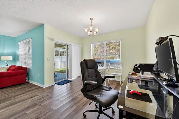 a view of a workspace with furniture and a window