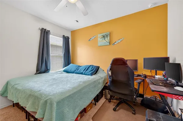 a bedroom with a bed and a desk