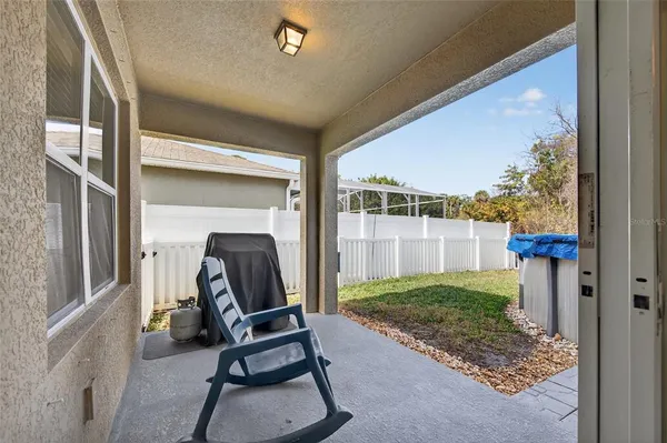 a view of a porch with furniture and a yard