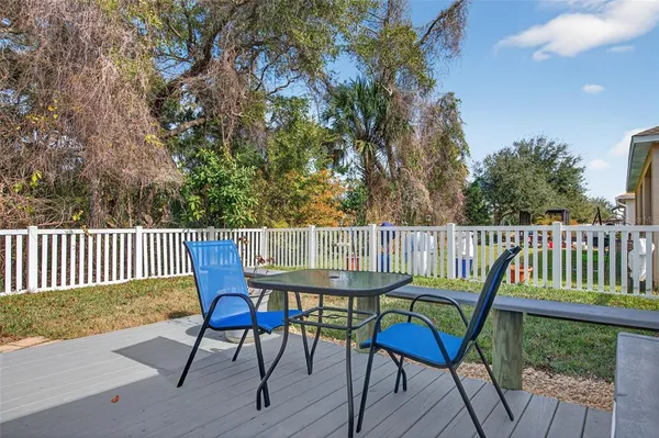 a view of a chair and table on the deck