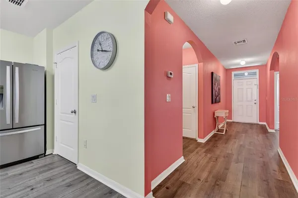 a view of hallway with wooden floor