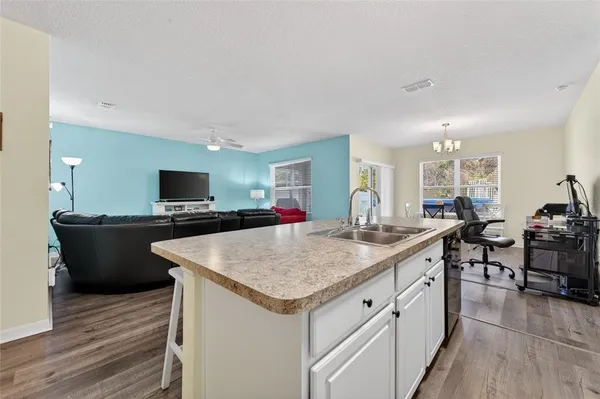 a kitchen with sink and cabinets