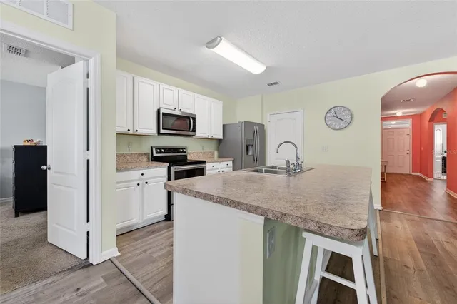 a kitchen with granite countertop a stove and a sink