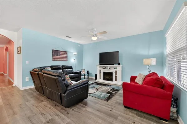 a living room with furniture a fireplace and a flat screen tv