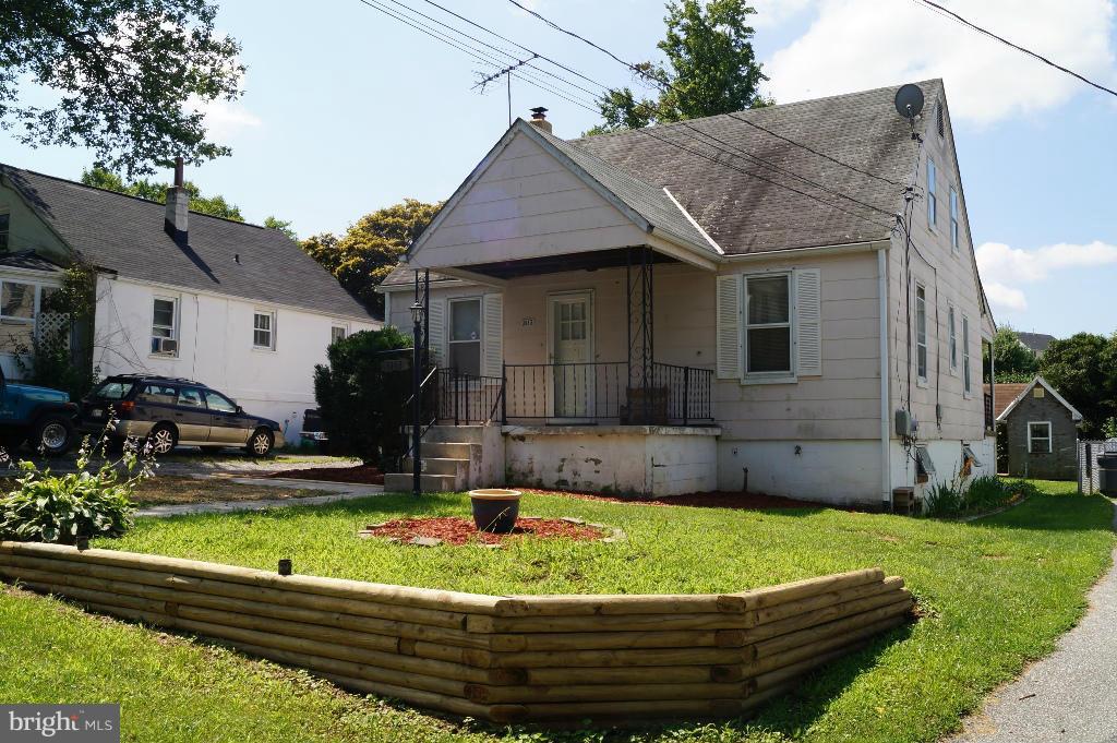 3113 Offutt Road Randallstown, MD 21133 - Photo 1 of 14 a front view of a house with a yard