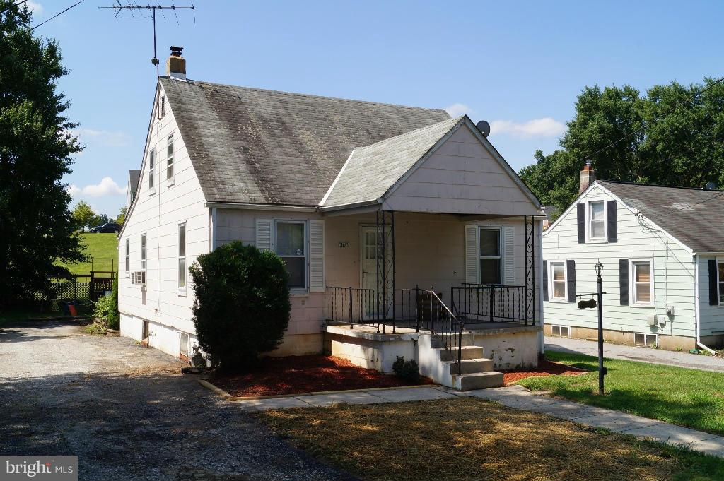 3113 Offutt Road Randallstown, MD 21133 - Photo 2 of 14 a front view of a house with a yard and garage