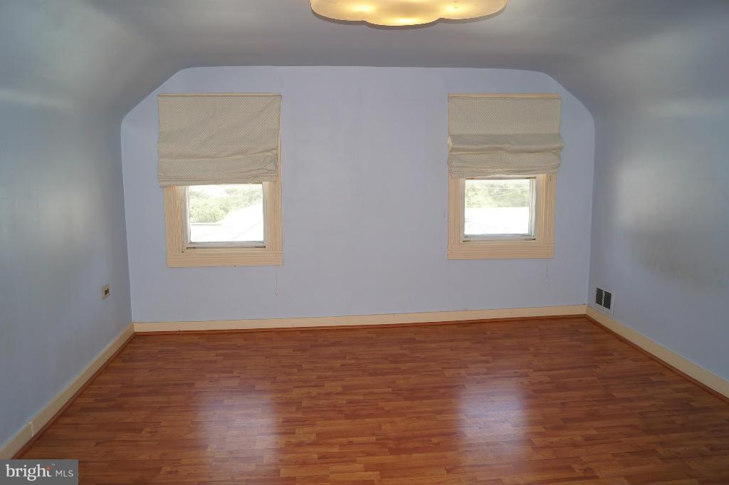 3113 Offutt Road Randallstown, MD 21133 - Photo 11 of 14 an empty room with wooden floor and windows