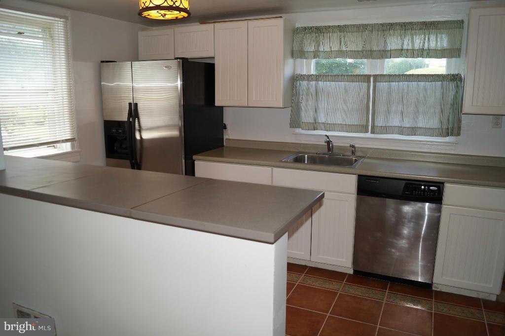 3113 Offutt Road Randallstown, MD 21133 - Photo 3 of 14 a kitchen with a sink a refrigerator and a stove