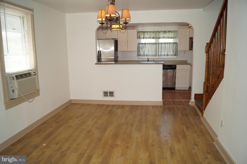 3113 Offutt Road Randallstown, MD 21133 - Photo 8 of 14 wooden floor in an empty room with a window