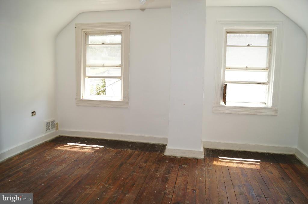 3113 Offutt Road Randallstown, MD 21133 - Photo 10 of 14 an empty room with wooden floor and windows