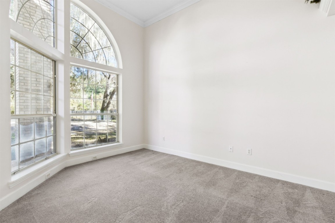 86305 Meadowfield Bluffs Road Yulee, FL 32097 - Photo 13 of 33 an empty room with wooden floor and windows