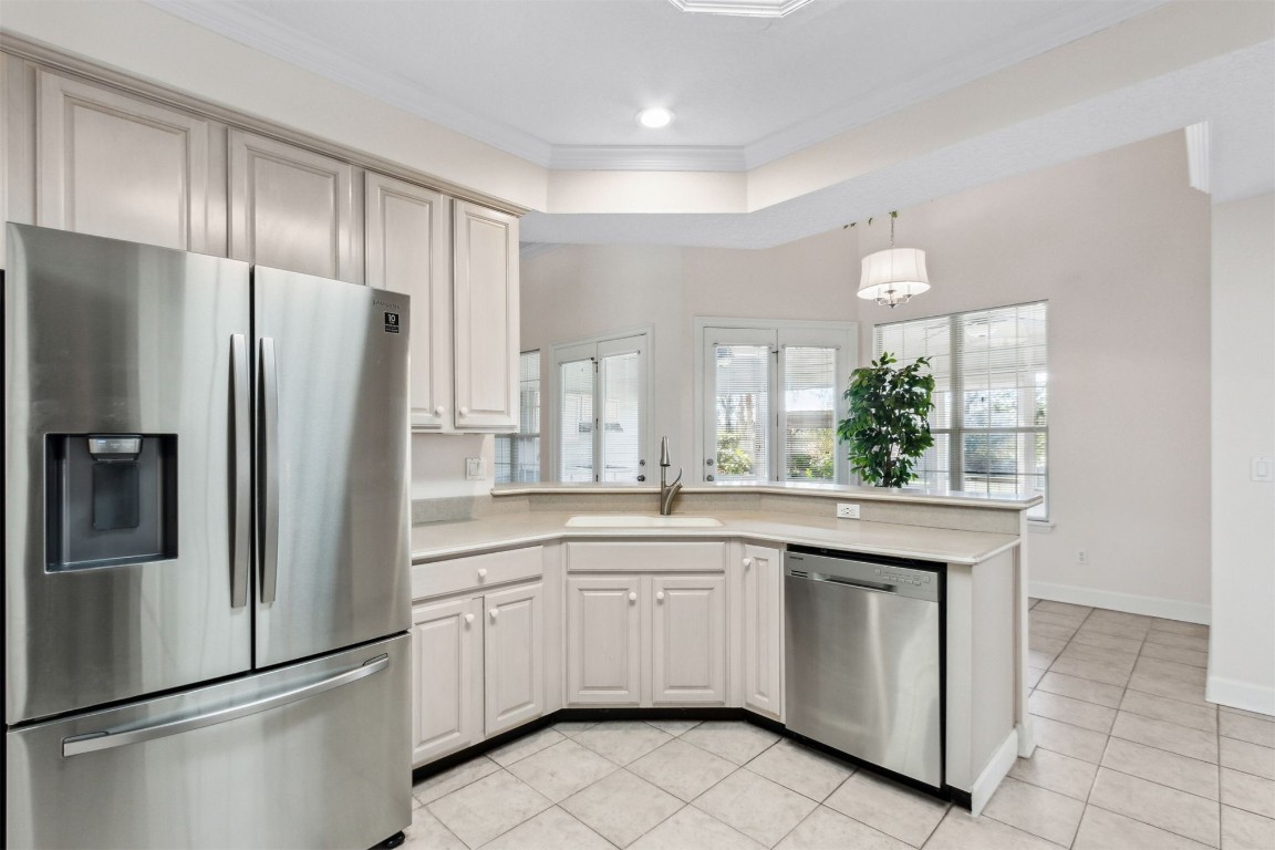 86305 Meadowfield Bluffs Road Yulee, FL 32097 - Photo 20 of 33 a kitchen with white cabinets and stainless steel appliances