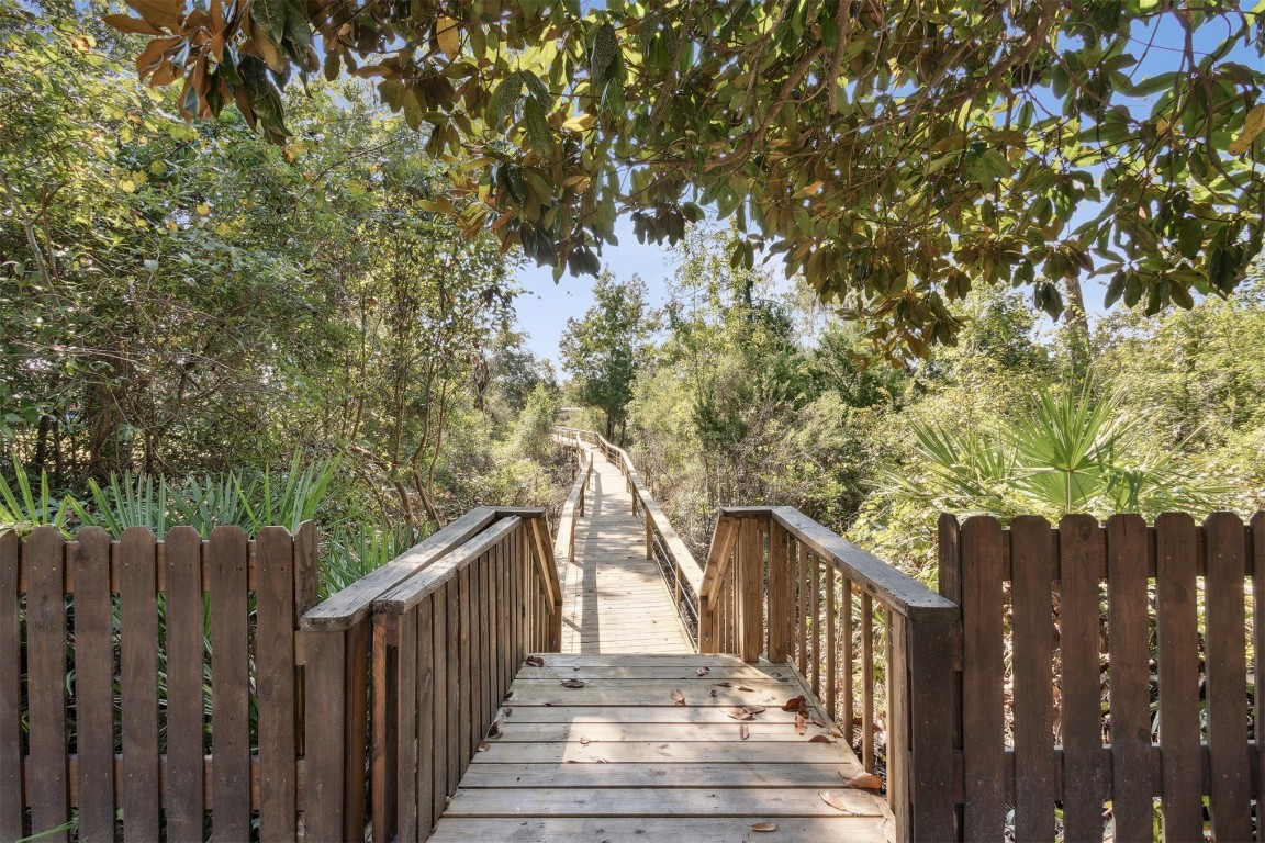 86305 Meadowfield Bluffs Road Yulee, FL 32097 - Photo 31 of 33 a view of deck with wooden fence and trees
