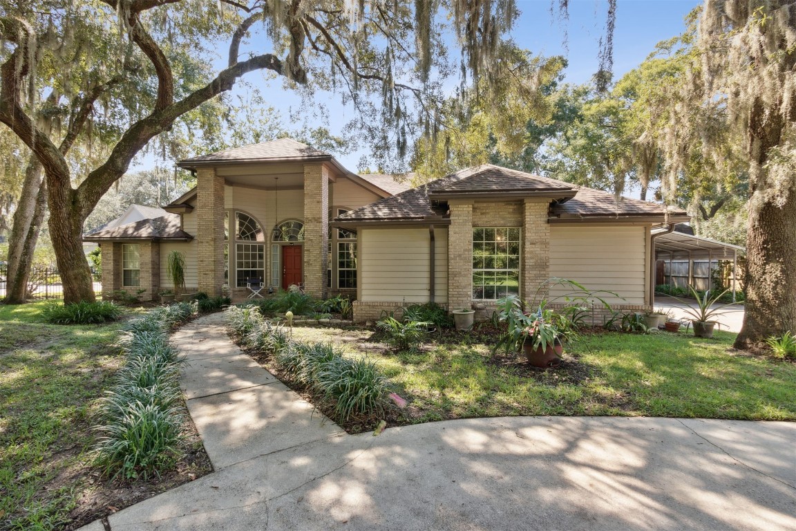 86305 Meadowfield Bluffs Road Yulee, FL 32097 - Photo 7 of 33 a front view of a house with a garden