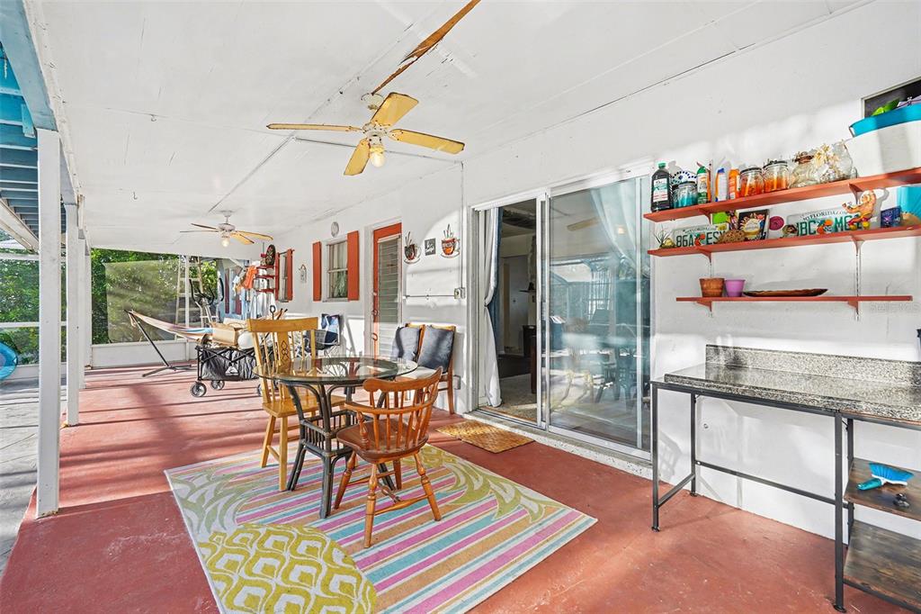 6686 Treehaven Drive Spring Hill, FL 34606 - Photo 20 of 29 a dining room with furniture a rug and a chandelier