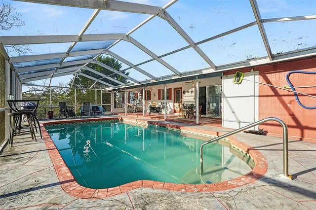 a view of a swimming pool with a patio