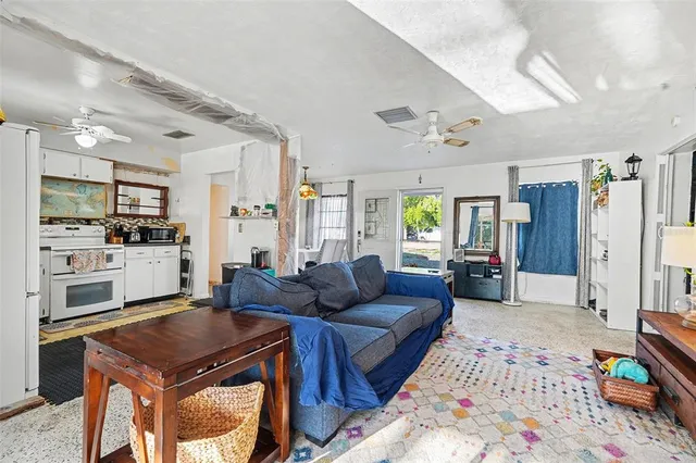 a living room with furniture and kitchen view