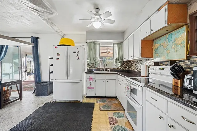 a kitchen with cabinets and window