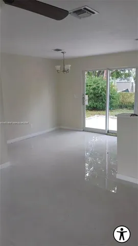 a view of a big room with windows and yard