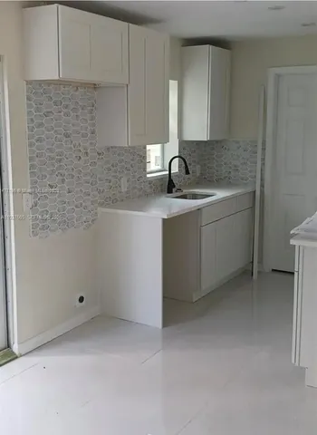 a kitchen with a sink and cabinets