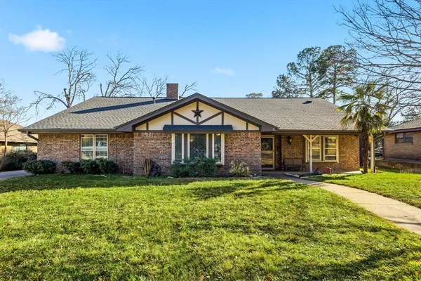 a front view of a house with a yard and porch