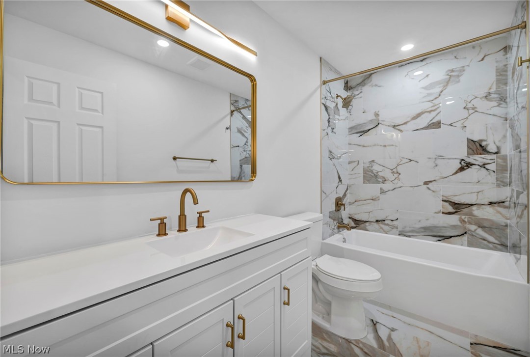 7602 Hickory Road Bedford, OH 44146 - Photo 18 of 36 Bathroom with shower / tub combination, vanity, and recessed lighting
