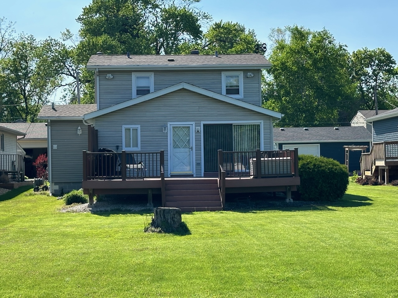 a view of a house with a yard and furniture