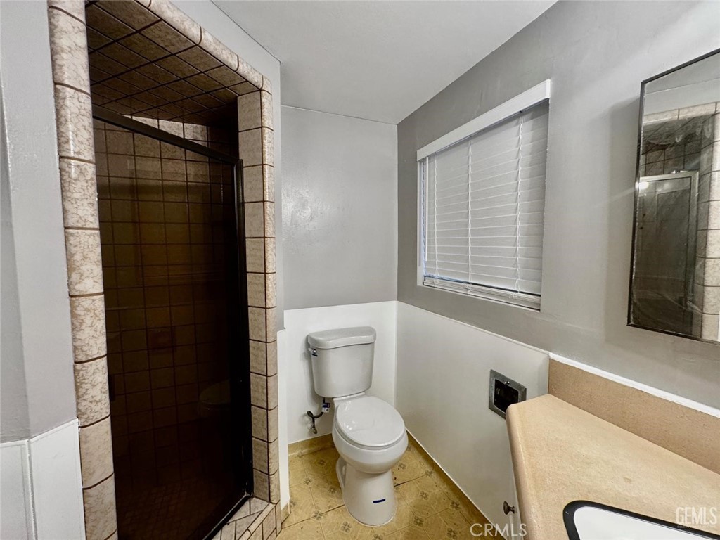 9 Dunlap Street Bakersfield, CA 93309 - Photo 20 of 22 a bathroom with a toilet a sink and shower