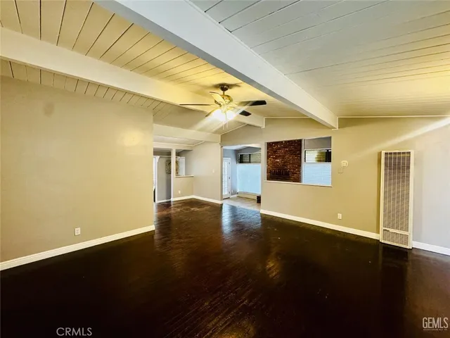 a view of a living room with wooden floor