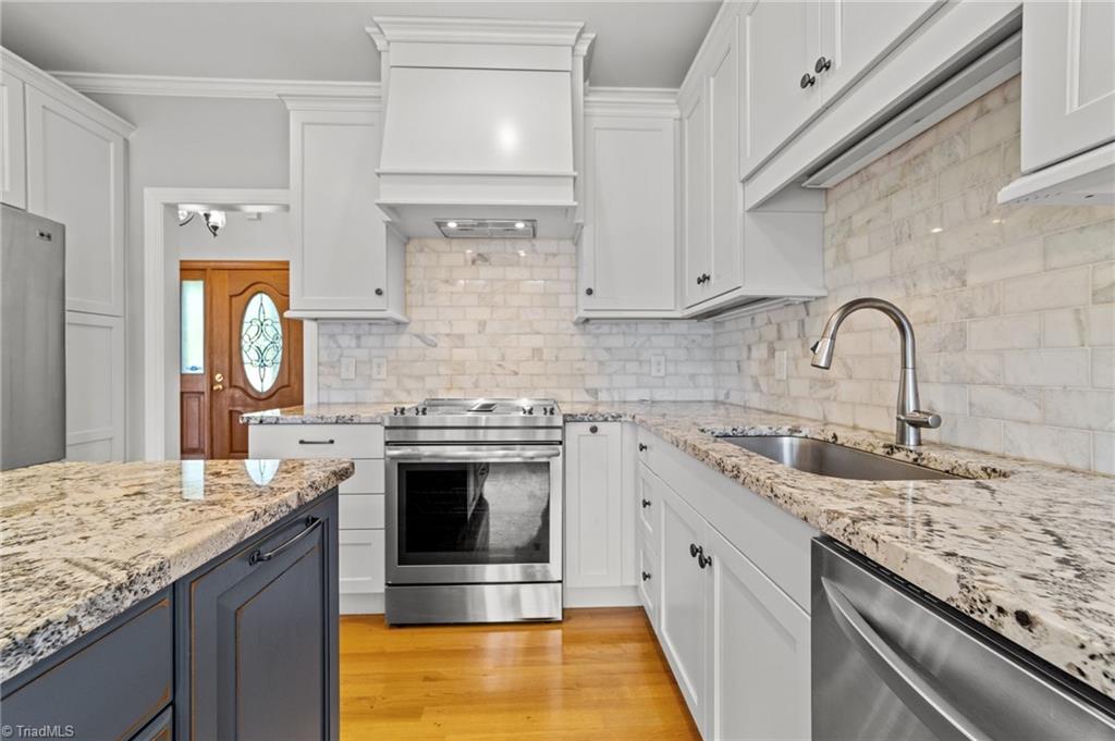 130 Deer Path Summerfield, NC 27358 - Photo 18 of 50 Kitchen with island, tile backsplash and lots of counterspaces.