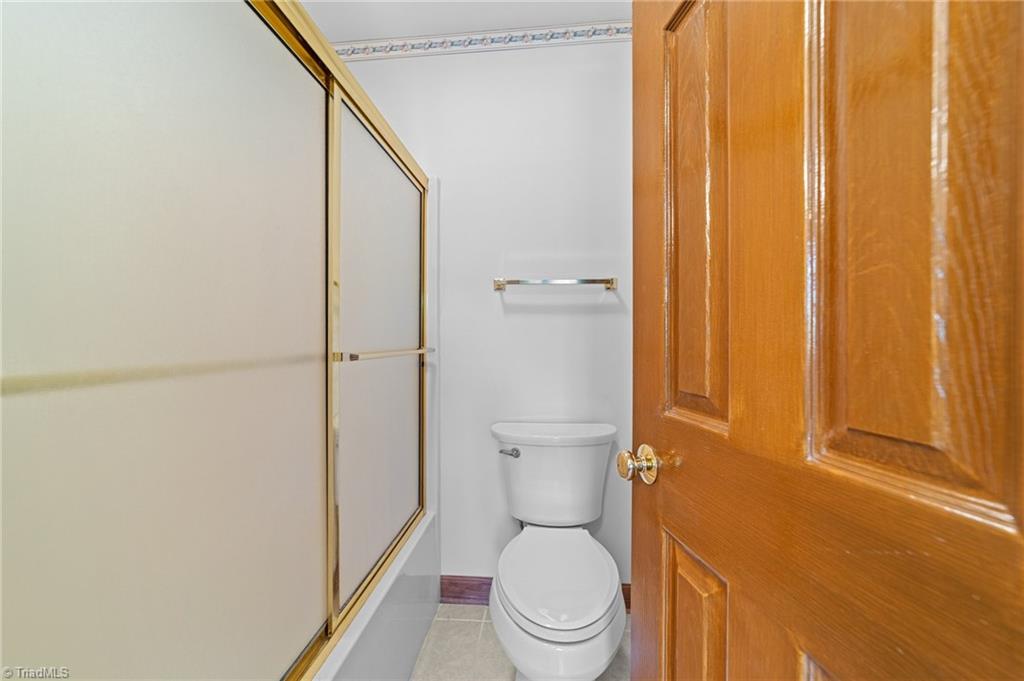 130 Deer Path Summerfield, NC 27358 - Photo 28 of 50 Full bathroom with shower and tub combo.