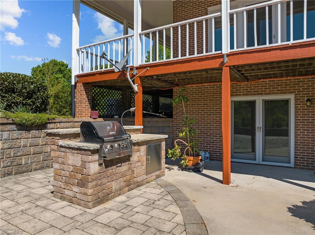 130 Deer Path Summerfield, NC 27358 - Photo 42 of 50 Outside with door the opens up to the basement of the home.