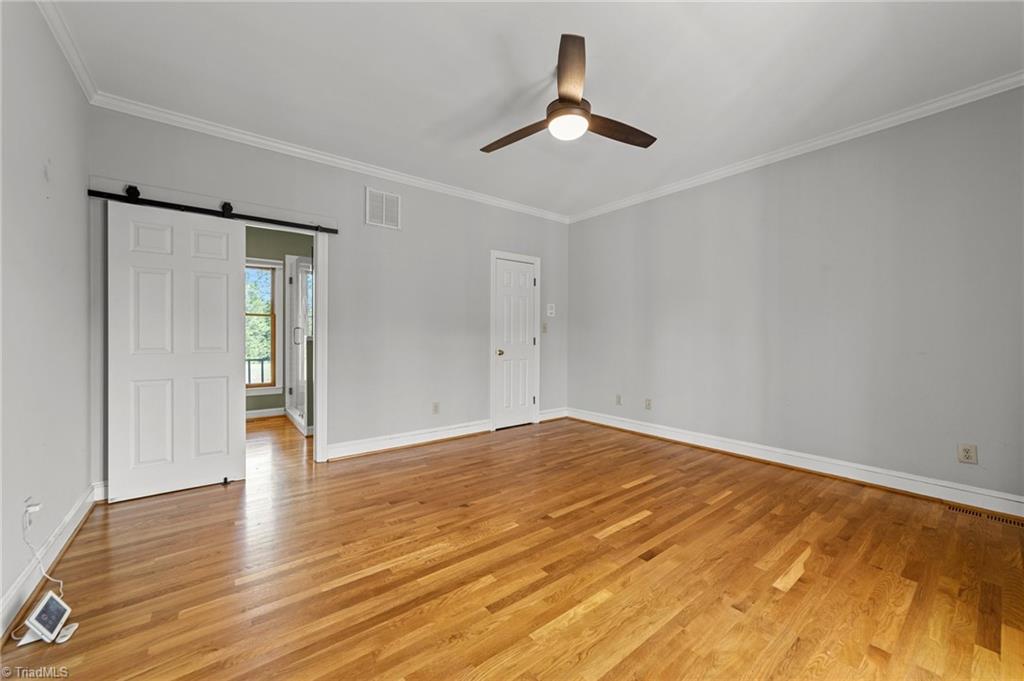130 Deer Path Summerfield, NC 27358 - Photo 8 of 50 Primary bedroom on the main floor with ensuite bathroom and walk in closet.