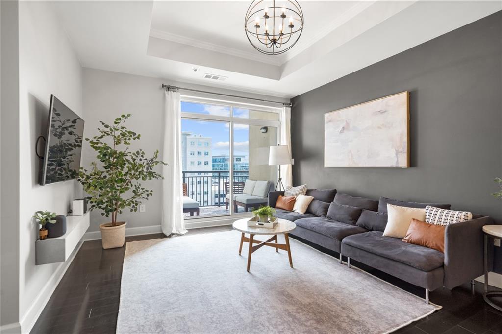 325 East Paces Ferry Road Northeast, Unit 903 Atlanta, GA 30305 - Photo 1 of 1 a living room with furniture and a large window