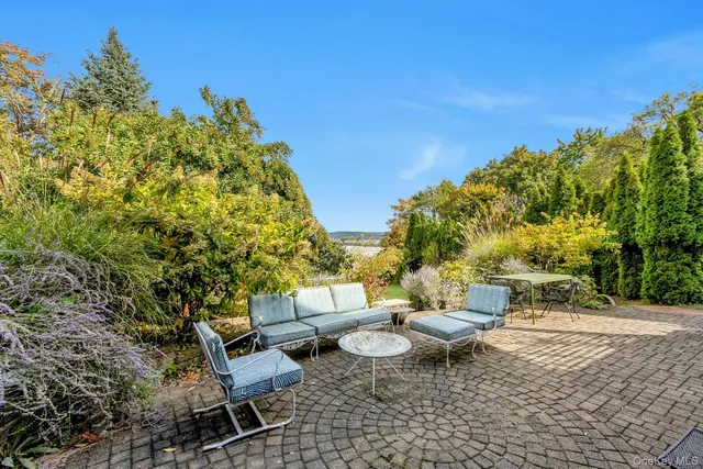 a view of a patio with table and chairs and potted plants