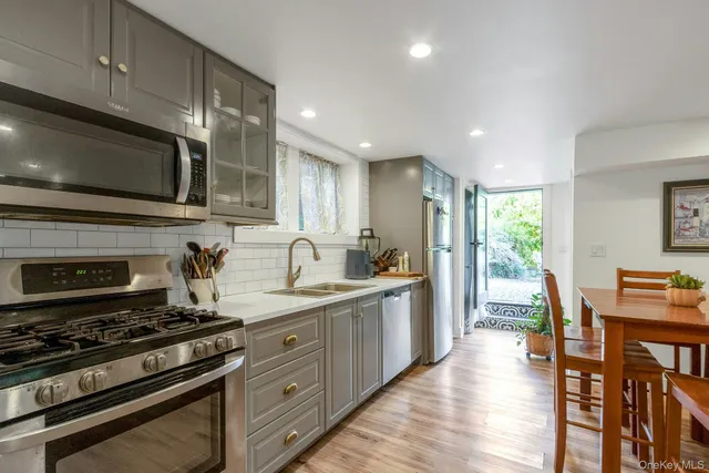 a kitchen with stainless steel appliances a stove microwave and cabinets