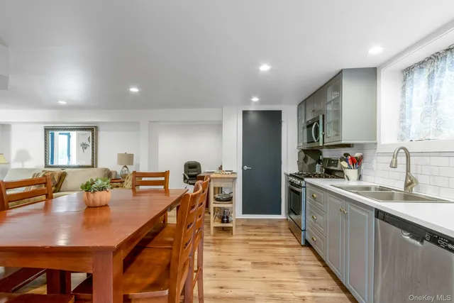 a large kitchen with stainless steel appliances lots of counter space and breakfast area