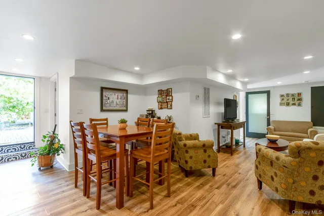 a view of a dining room with furniture window and wooden floor