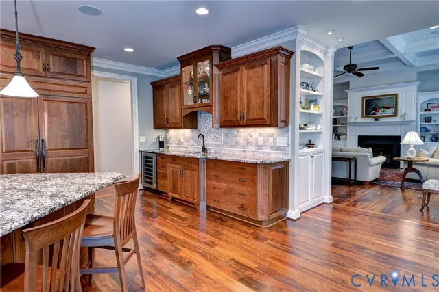 a kitchen with stainless steel appliances granite countertop a sink and a stove