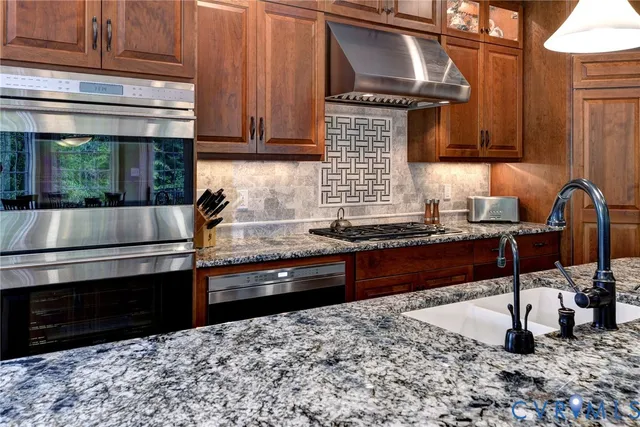 a kitchen with granite countertop stainless steel appliances and cabinets