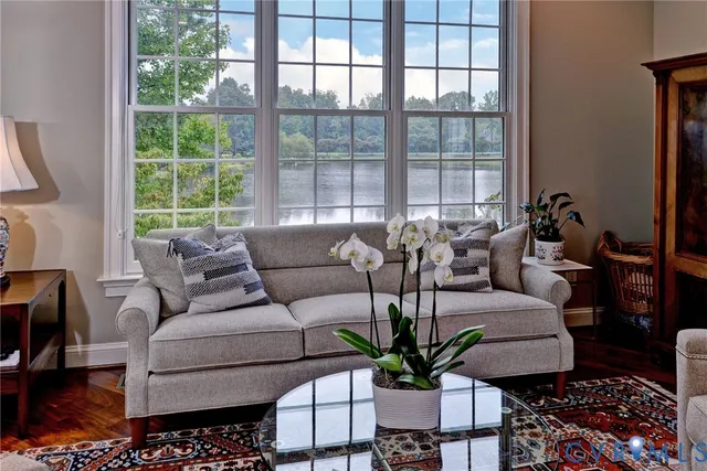 a kitchen with granite countertop a dining table chairs stove a refrigerator and wooden floor