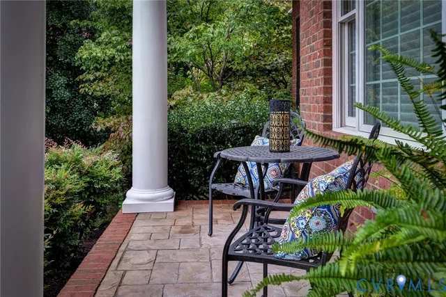 a view of a chairs and table in a patio with a fountain