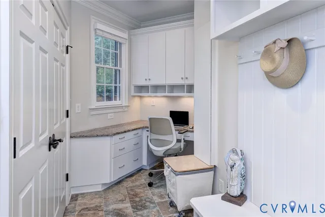a kitchen with granite countertop cabinets and entryway