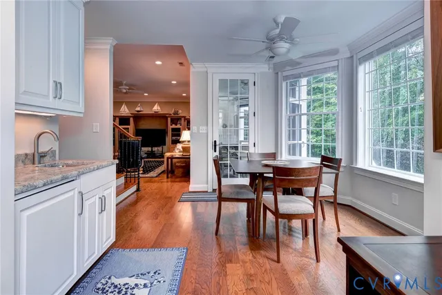 a view of a dining room with furniture window and wooden floor